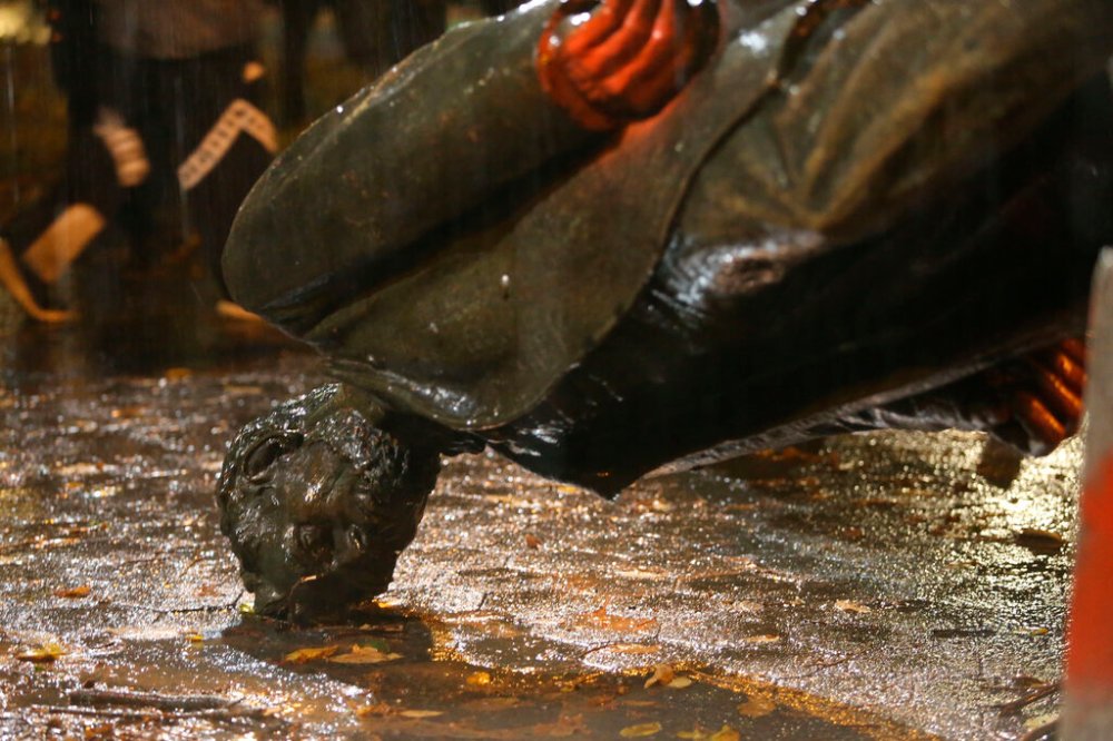 A group of protesters toppled statues of former presidents Theodore Roosevelt and Abraham Lincoln in Portland's South Park Block late Sunday. (Sean Meagher/The Oregonian via AP)