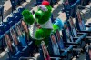 The Phillie Phanatic tries to interact with the cardboard cutouts of the fans in the stands during the third inning of a baseball game against the Miami Marlins, Sunday, July 26, 2020, in Philadelphia. (AP Photo/Chris Szagola)