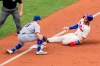 Philadelphia Phillies' Bryce Harper, right, gets tagged out by New York Mets third baseman J.D. Davis, left, during the third inning of a baseball game, Sunday, Aug. 16, 2020, in Philadelphia. (AP Photo/Chris Szagola)