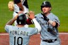 Chicago White Sox's Yasmani Grandal (24) celebrates with Yoan Moncada as he heads to the dugout after hitting a two-run home run off Pittsburgh Pirates relief pitcher Dovydas Neverauskas during the fifth inning of a baseball game in Pittsburgh, Tuesday, Sept. 8, 2020. (AP Photo/Gene J. Puskar)