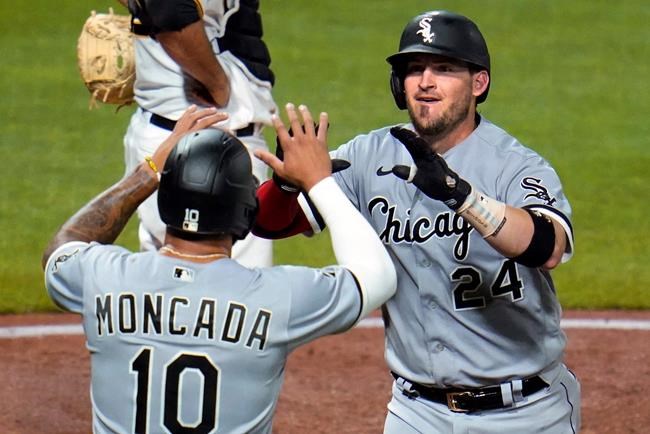 Chicago White Sox's Yasmani Grandal (24) celebrates with Yoan Moncada as he heads to the dugout after hitting a two-run home run off Pittsburgh Pirates relief pitcher Dovydas Neverauskas during the fifth inning of a baseball game in Pittsburgh, Tuesday, Sept. 8, 2020. (AP Photo/Gene J. Puskar)