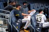 Pittsburgh Pirates starting pitchers from left Trevor Williams, Joe Musgrove, Chad Kuhl and Steven Brault (43) sit in the stands during a baseball game against the Cleveland Indians in Pittsburgh, Tuesday, Aug. 18, 2020. (AP Photo/Gene J. Puskar)