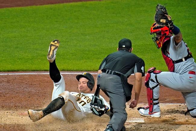Pittsburgh Pirates' Bryan Reynolds, left, is tagged out by St. Louis Cardinals catcher Yadier Molina, right, with umpire Robert Ortiz preparing to make the call during the sixth inning of a baseball game in Pittsburgh, Thursday, Sept. 17, 2020. (AP Photo/Gene J. Puskar)