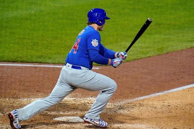 Chicago Cubs' Anthony Rizzo watches the ball he hit toward Pittsburgh Pirates shortstop Kevin Newman, who committed an error during the eighth inning of a baseball game in Pittsburgh, Wednesday, Sept. 2, 2020. Two runs scored. The Cubs won 8-2. (AP Photo/Gene J. Puskar)