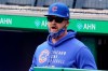 Chicago Cubs manager David Ross stands in the dugout during a baseball game against the Pittsburgh Pirates in Pittsburgh, Sunday, April 11, 2021. (AP Photo/Gene J. Puskar)