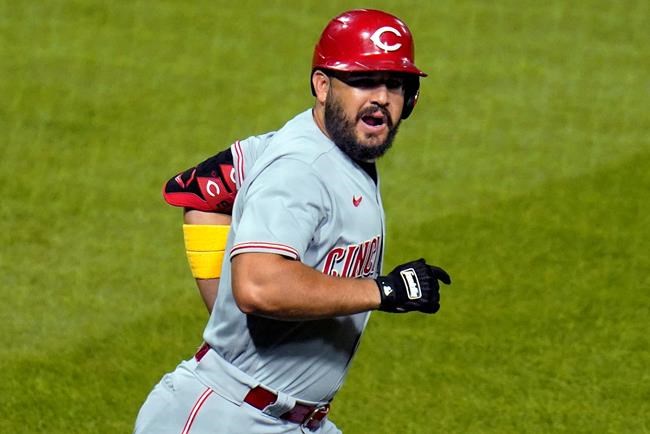 Cincinnati Reds' Eugenio Suarez celebrates as rounds first base after hitting a three-run home run off Pittsburgh Pirates starting pitcher Trevor Williams during the third inning of a baseball game in Pittsburgh, Saturday, Sept. 5, 2020. It was the first of two homers in the game for Suarez off Williams. (AP Photo/Gene J. Puskar)