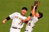 Pittsburgh Pirates second baseman Adam Frazier (26) makes the catch on a fly ball by Chicago Cubs' Cameron Maybin as he collides with left fielder Jared Oliva to end a baseball game in Pittsburgh, Thursday, Sept. 24, 2020. The Pirates won 7-0. (AP Photo/Gene J. Puskar)