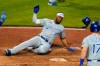 Kansas City Royals' Jorge Soler (12) scores on a two-run double by Andrew Benintendi off Pittsburgh Pirates pitcher Chris Stratton during the sixth inning of a baseball game in Pittsburgh, Wednesday, April 28, 2021.(AP Photo/Gene J. Puskar)