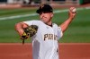 Pittsburgh Pirates starter Derek Holland pitches against the Milwaukee Brewers in the first inning of a baseball game, Saturday, Aug. 22, 2020, in Pittsburgh. (AP Photo/Keith Srakocic)