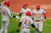 Cincinnati Reds' Kyle Farmer (17) and Tucker Barnhart, center, celebrate with teammates Jesse Winker (33) and Nick Castellanos (2) after scoring on a hit by Nick Senzel off Pittsburgh Pirates relief pitcher Duane Underwood Jr. in the fourth inning of a baseball game, Monday, May 10, 2021, in Pittsburgh. (AP Photo/Keith Srakocic)