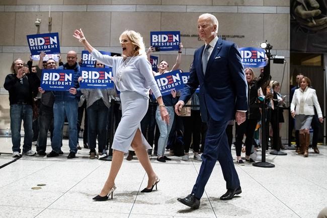 Democratic presidential candidate former Vice President Joe Biden, accompanied by his wife Jill arrives to speak to members of the press at the National Constitution Center in Philadelphia, Tuesday, March 10, 2020. (AP Photo/Matt Rourke)