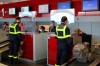 Members of the Securite Civile rescue organisation wait at the boarding desk at Charles de Gaulle airport, north of Paris, Wednesday, Aug.5, 2020. France is sending two planes to Lebanon on Wednesday with dozens of emergency workers, a mobile medical unit and 15 tons of aid. The aid is expected to arrive Wednesday afternoon and should allow for the treatment of some 500 blast victims, according to French President Emmanuel Macron's office. (AP Photo/Thibault Camus)