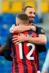 Milan's Ante Rebic celebrates after scoring his side's first goal, with teammate Zlatan Ibrahimovic, who gave him the assist, during the Italian Serie A soccer match between Parma and Milan at the Ennio Tardini stadium in Parma, Italy, Saturday, April 10, 2021. (Spada/LaPresse via AP)