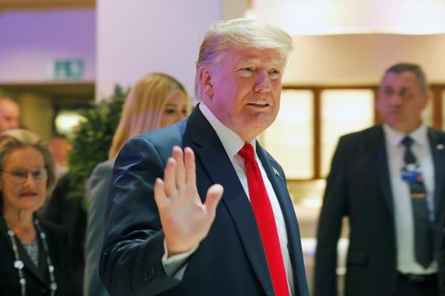 U.S. President Donald Trump waves as he arrives at the World Economic Forum in Davos, Switzerland, Wednesday, Jan. 22, 2020. The 50th annual meeting of the forum is taking place in Davos from Jan. 21 until Jan. 24, 2020. (AP Photo/Markus Schreiber)