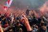 Ajax supporters celebrate outside the Arena as their team scored their second goal in the Dutch Eredivisie Premier League title during the soccer match between Ajax and Emmen at the Johan Cruyff ArenA in Amsterdam, Netherlands, Sunday, May 2, 2021. (AP Photo/Peter Dejong)