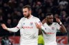 Lyon's Maxwel Cornet, right, gestures as he celebrates with teammate Lucas Tousart, left, who scored his side's first goal during a round of sixteen, first leg, soccer match between Lyon and Juventus at the at the Lyon Olympic Stadium in Decines, outside Lyon, France, Wednesday, Feb. 26, 2020. (AP Photo/Laurent Cipriani)