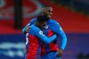 Crystal Palace's Christian Benteke, right, hugs Crystal Palace's Jeffrey Schlupp, left, who scored his side's first goal during the English Premier League soccer match between Crystal Palace and Sheffield United in London, England, Saturday, Jan. 2, 2021. (Clive Rose/Pool via AP)