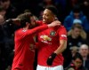 Manchester United's Anthony Martial hugs teammate Juan Mata, left, who scored his side's first goal during the English FA Cup third round replay soccer match between Manchester United and Wolverhampton Wanderers at Old Trafford in Manchester, England, Wednesday, Jan. 15, 2020. (AP Photo/Rui Vieira)