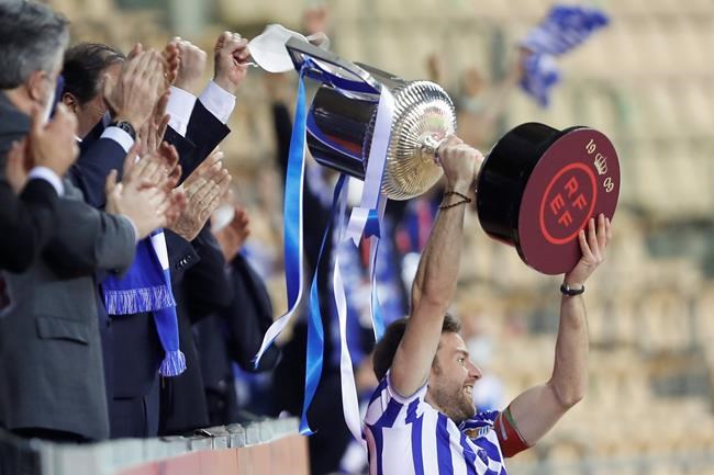Real Sociedad's Martin Zubimendi celebrates with the trophy after winning the final of the 2020 Copa del Rey, or King's Cup, soccer match between Athletic Bilbao and Real Sociedad at Estadio de La Cartuja in Sevilla, Spain, Saturday April 3, 2021. The game is the rescheduled final of the 2019-2020 competition which was originally postponed due to the coronavirus pandemic. (AP Photo/Angel Fernandez)