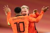 Netherlands' Donny van de Beek, rear, celebrates with Netherlands' Memphis Depay after he scored his side's first goal during the international friendly soccer match between The Netherlands and Spain at the Johan Cruyff ArenA in Amsterdam, Netherlands, Wednesday, Nov. 11, 2020. (Dean Mouhtaropoulos/Pool via AP)