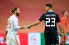 Spain's Sergio Ramos, left, and Spain's goalkeeper Unai Simon, right, talks after the international friendly soccer match between The Netherlands and Spain at the Johan Cruyff ArenA in Amsterdam, Netherlands, Wednesday, Nov. 11, 2020. Ramos came on as an 85th-minute substitute for his 176th international, drawing level with former Italy goalkeeper Gianluigi Buffon as the European with the most caps. The world record is Ahmed Hassan's 184 for Egypt. (Dean Mouhtaropoulos/Pool via AP)