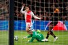 Valencia's goalkeeper Jaume Domenech saves on a shot by Ajax's Sergino Dest, center, during the group H Champions League soccer match between Ajax and Valencia at the Johan Cruyff ArenA in Amsterdam, Netherlands, Tuesday, Dec. 10, 2019. (AP Photo/Peter Dejong)