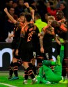 Valencia players celebrate after the group H Champions League soccer match between Ajax and Valencia at the Johan Cruyff ArenA in Amsterdam, Netherlands, Tuesday, Dec. 10, 2019. (AP Photo/Peter Dejong)