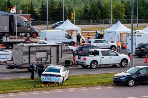 Motorists from the mainland go through checkpoints after they came off Confederation Bridge in Borden-Carleton, P.E.I., Friday, July 7, 2020. THE CANADIAN PRESS/Brian McInnis