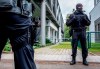 German police officers stand in front of the German football association DFB headquarters in Frankfurt, Germany, Wednesday, Oct.7, 2020. The public prosecutor's office in Frankfurt searched the offices of the DFB as well as the private homes of DFB officials on suspicion of tax evasion in particularly serious cases.2020. (AP Photo/Michael Probst)