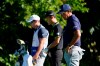 Phil Mickelson, right, Kevin Na, center, and their caddie observe a moment of silence not the 13th tee during the first round of the Charles Schwab Challenge golf tournament at the Colonial Country Club in Fort Worth, Texas, Thursday, June 11, 2020. Players at the 8:46 a.m. tee time paused to pay their respects to the memory of George Floyd for a moment of silence, prayer and reflection. (AP Photo/David J. Phillip)