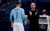 Manchester City's head coach Pep Guardiola, right, talks to Manchester City's Kyle Walker during the Champions League semifinal first leg soccer match between Paris Saint Germain and Manchester City at the Parc des Princes stadium, in Paris, France , Wednesday, April 28, 2021. (AP Photo/Thibault Camus)