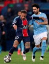 Manchester City's Ilkay Gundogan, right, challenges PSG's Neymar during the Champions League semifinal first leg soccer match between Paris Saint Germain and Manchester City at the Parc des Princes stadium, in Paris, France , Wednesday, April 28, 2021. (AP Photo/Thibault Camus)