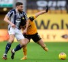 West Bromwich Albion's Robert Snodgrass, left, challenges Wolverhampton Wanderers' Pedro Neto during the English Premier League soccer match between Wolverhampton Wanderers and West Bromwich Albion at the Molineux Stadium in Wolverhampton, England, Saturday, Jan. 16, 2021. (Carl Recine/Pool via AP)