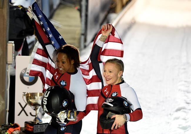 Kaillie Humphries, right, and Lauren Gibbs of the US celebrate after winning the two-woman bobsled competition at the Bobsleigh and Skeleton World Championships in Altenberg, Germany, Saturday, Feb. 22, 2020. (AP Photo/Jens Meyer)