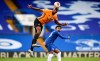 Chelsea's Willian, right, watches Wolverhampton Wanderers' Willy Boly leaping for a header during the English Premier League soccer match between Chelsea and Wolverhampton Wanderers at Stamford Bridge, in London, Sunday July 26, 2020. (Daniel Leal-Olivas/Pool via AP)