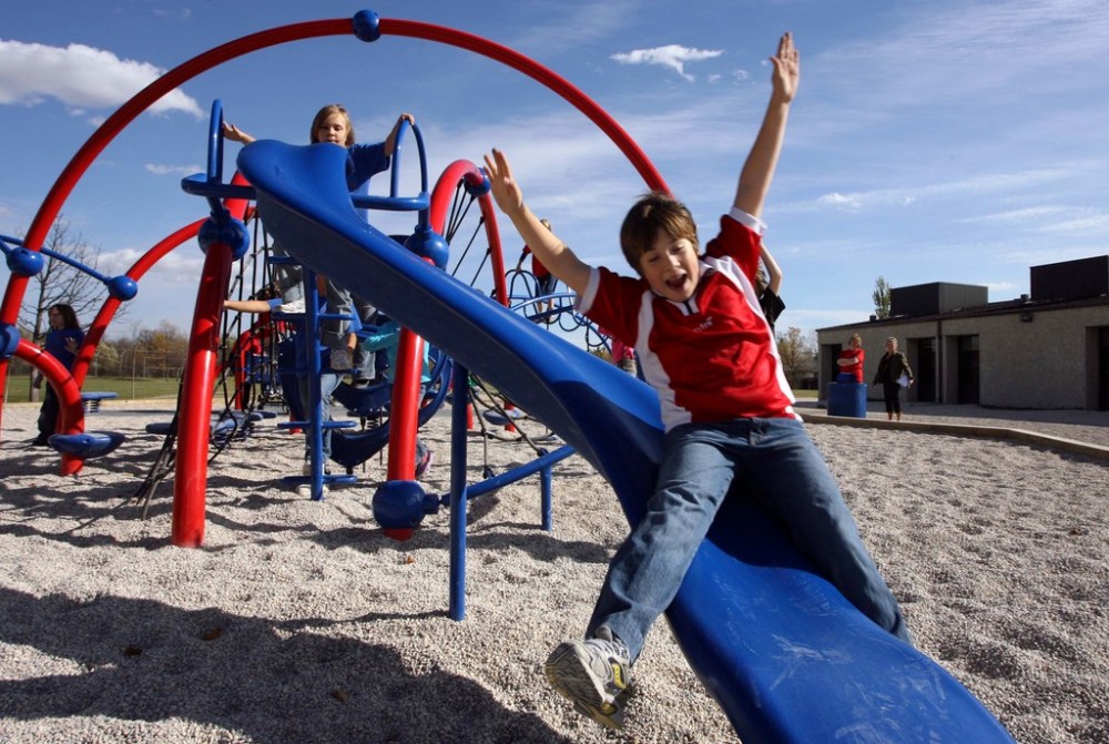Students enjoy a play structure at Pacific Junction School back when playgrounds were open. Newer play structures are composed of metal and plastic, surfaces that coronavirus is known to live on for up to 72 hours. (Mike Deal / Winnipeg Free Press files)