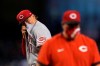 Cincinnati Reds starting pitcher Jose De Leon, left, wipes sweat from his face after getting a visit from Reds pitching coach Derek Johnson, right, as a result of giving up a three-run home run to Arizona Diamondbacks' David Peralta and during the third inning of a baseball game Sunday, April 11, 2021, in Phoenix. (AP Photo/Ross D. Franklin)