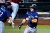 Seattle Mariners' Dylan Moore, right, celebrates his run scored against the Arizona Diamondbacks with teammate Evan White, left, during the ninth inning of a baseball game Sunday, Sept. 13, 2020, in Phoenix. (AP Photo/Ross D. Franklin)