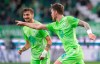 Wolfsburg's Wout Weghorst, right, celebrates his side's opening goal during a German Bundesliga soccer match between VfL Wolfsburg and Arminia Bielefeld in Wolfsburg, Germany, Sunday, Oct.25, 2020. (Peter Steffen/dpa via AP)