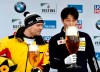 Yun Sung Bin from South Korea zips from a giant glass of beer after winning the men's Skeleton world cup in Winterberg, Germany, Sunday, Jan.5, 2019. Germany's Axel Jungk at left.(Caroline Seidel/dpa via AP)