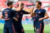 Robert Lewandowski, left, of Munich celebrates his team's fourth goal with teammates Thomas Mueller, center, and Leon Goretzka during the German Bundesliga soccer match between Bayer Leverkusen and Bayern Munich in Leverkusen, Germany, Saturday, June 6, 2020. (Matthias Hangst, Pool via AP)