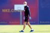 In this photo provided by FC Barcelona, Barcelona's coach Quique Setien watches his players doing a training session in Barcelona, Spain on Friday May 8, 2020. Soccer players in Spanish player returned to train for the first time since the country entered a lockdown nearly two months ago because of the coronavirus pandemic. (Miguel Ruiz/FC Barcelona via AP)