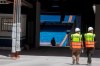 Workers walk into Real Madrid's Santiago Bernabeu stadium in Madrid, Spain, Monday, May 25, 2020. Spanish league clubs are now allowed to train with groups of up to 14 players as the league stays on track to restart in less than three weeks. (AP Photo/Paul White)