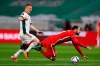 Poland's Grzegorz Krychowiak, right falls in front of Hungary's Laszlo Kleinheisler during the World Cup 2022 group I qualifying soccer match between Hungary and Poland at the Puskas Arena in Budapest, Hungry Thursday March 25, 2021. (AP Photo/Laszlo Balogh)