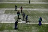 Workers clear snow from the pitch before the start of a Spanish La Liga soccer match between Osasuna and Real Madrid at El Sadar stadium in Pamplona, Spain, Saturday, Jan. 9, 2021. (AP Photo/Alvaro Barrientos)