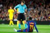 The referee speaks with Barcelona's Ousmane Dembele who had to be substituted after getting injured during a Champions League soccer match Group F between Barcelona and Dortmund at the Camp Nou stadium in Barcelona, Spain, Wednesday, Nov. 27, 2019. (AP Photo/Joan Monfort)