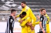Fulham players celebrate after their side's opening goal scored by Newcastle's Matt Ritchie in his own net during an English Premier League soccer match between Newcastle United and Fulham at the St. James' Park stadium in Newcastle, England, Saturday Dec. 19, 2020. (Alex Pantling/Pool via AP)