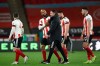 Sheffield United's David McGoldrick, 2nd left shakes hands with the team's manager Paul Heckingbottom at the end of an English Premier League soccer match between Sheffield United and Brighton Hove Albion at the Bramall Lane stadium in Sheffield, England, Saturday April 24, 2021. (Tim Goode/Pool via AP)