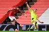 Manchester United's Marcus Rashford, left, shoots to score the opening goal during an English Premier League soccer match between Manchester United and Newcastle at the Old Trafford stadium in Manchester, England, Sunday Feb. 21, 2021. (Stu Forster/Pool via AP)