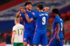 England's Dominic Calvert-Lewin, centre, celebrates with Tyrone Mings after scoring his side's third goal from a penalty kick during the international friendly soccer match between England and Ireland at Wembley stadium in London, England, Thursday Oct. 12, 2020. (Mike Egerton/Pool via AP)